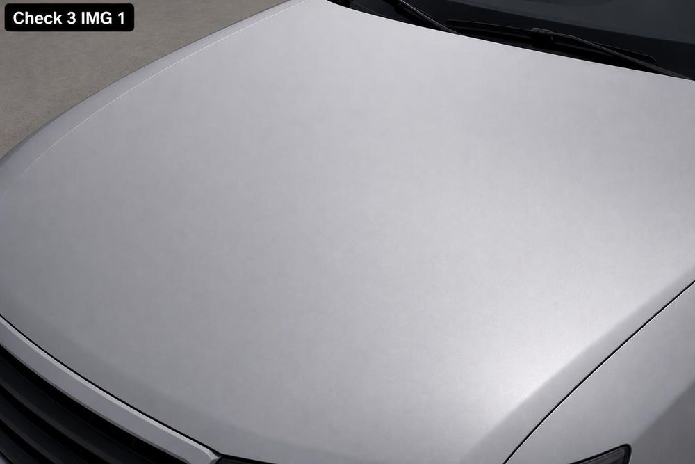 Inspecting a car body panel for paint texture consistency and signs of dent repair